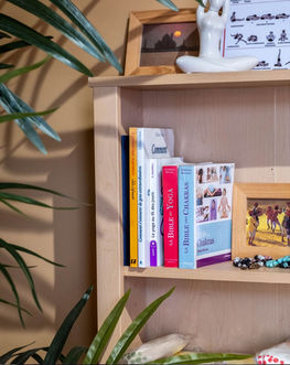 Om Yoga + Pilates studio's boutique with yoga books on a shelf.