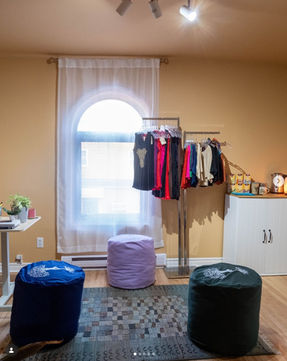 Om Yoga + Pilates studio's boutique with several products to sell such as yoga clothing