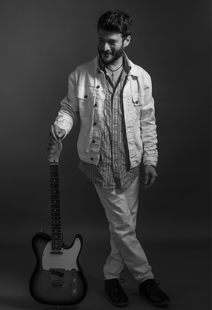 Bryan Holding Guitar Upright