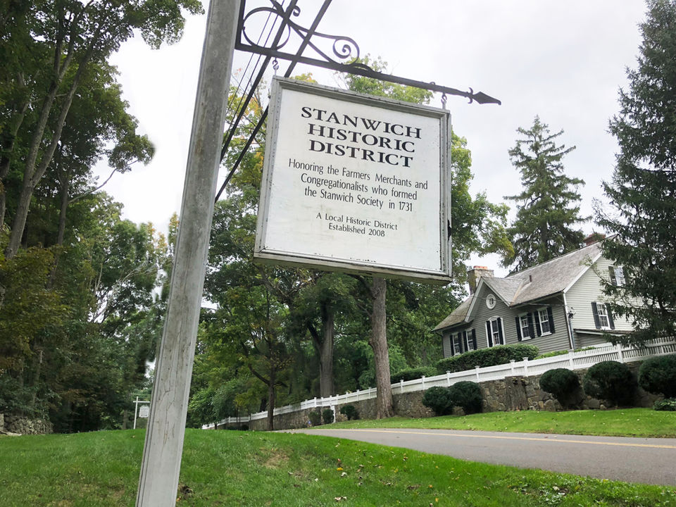 protected historic property sign, grey clapboard house