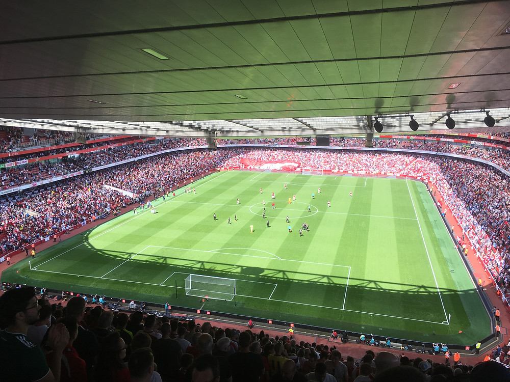 Players line up before the start of the second half at the Emirates on Sunday
