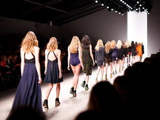 Female runway models in a line during catwalk fashion show
