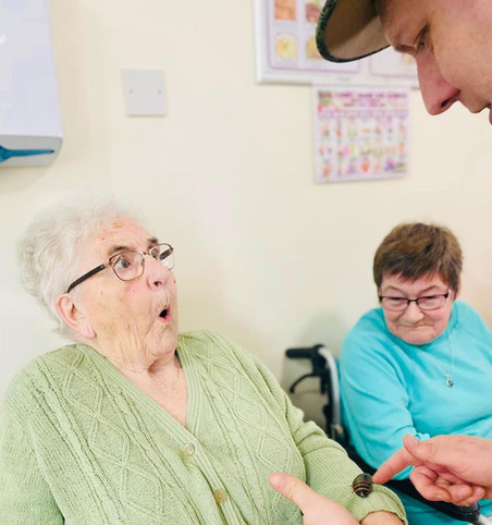 A lady is shocked to meet Craig the cockroach who is sitting on her sleeve while a friend looks on.