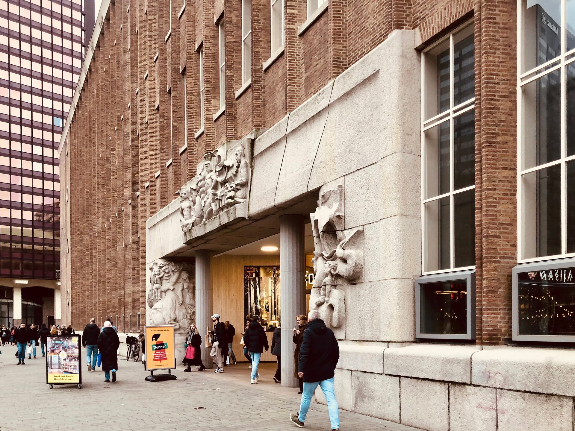 imposing white stone entrance with sculptures restof building red brickwork