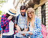 woman-taking-photo-camera-while-her-friends-looking-map.jpg