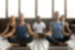 Young diverse group of people doing yoga breathing exercises