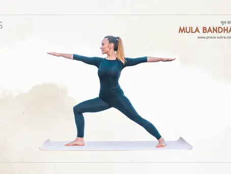 A woman practicing Mula Bandha in Warrior Pose II