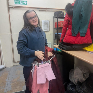Female volunteer worker in Womn's Aid Charity Shop 