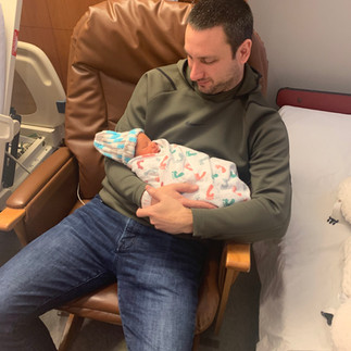 dad holding newborn at hospital