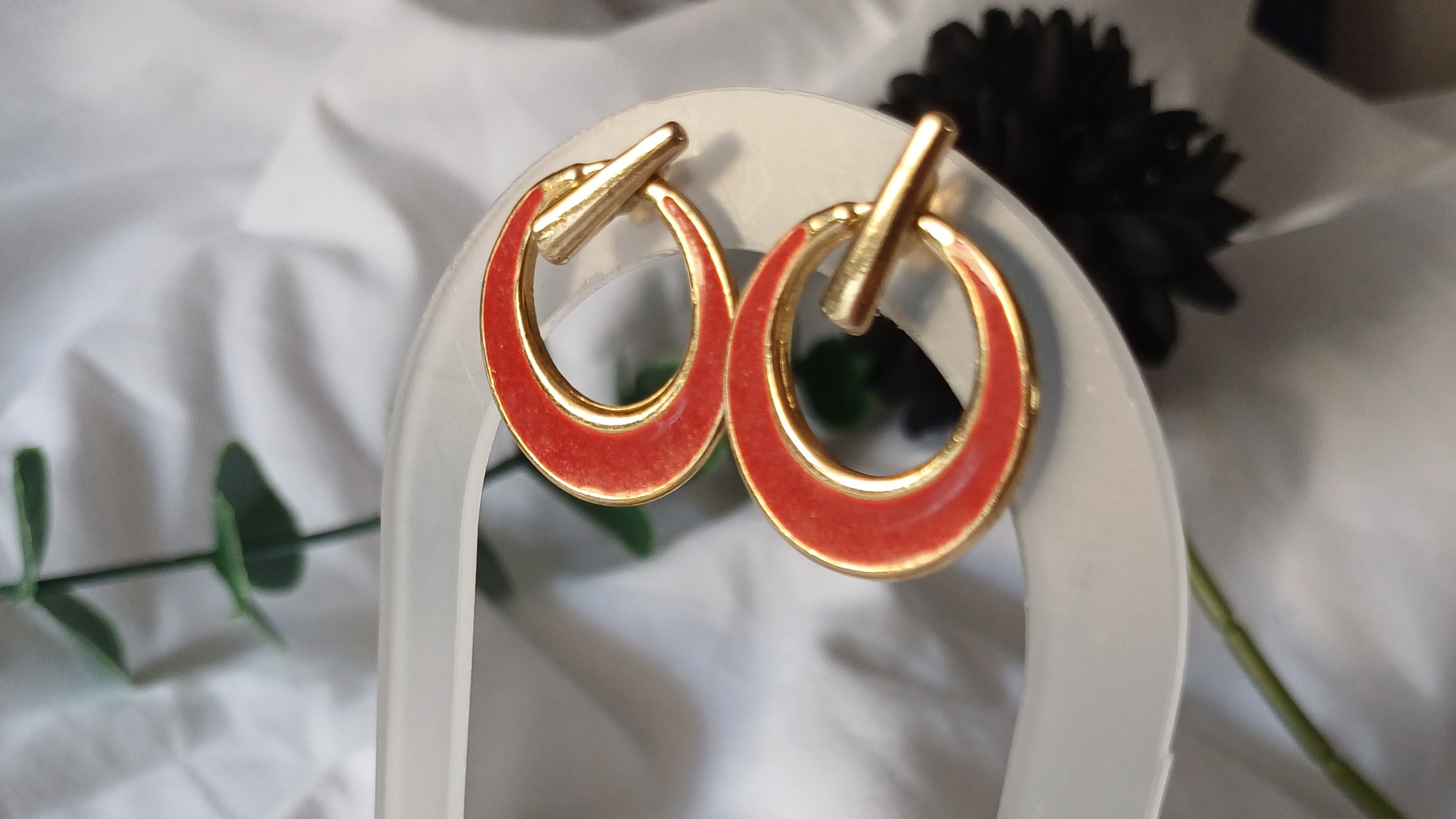 Close-up view of preloved rings and handmade earrings on a linen cloth.