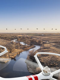 Drone transporting scientific instruments for real-time data collection. Provides immediate insights by delivering observation equipment to specific locations.