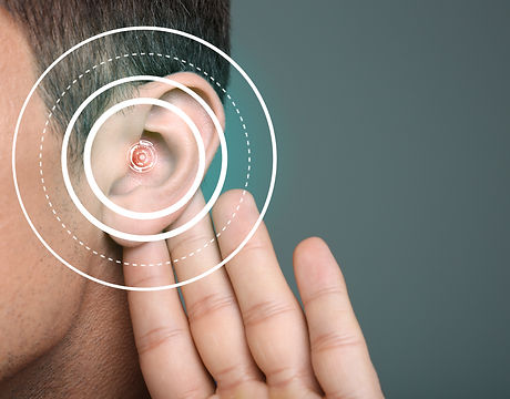 Young man with symptom of hearing loss on color background.jpg