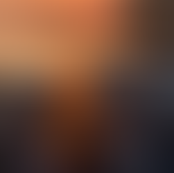 Campfire on the water near a pier at sunset