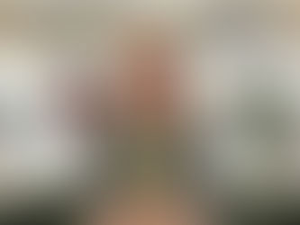 Lea Appleton sitting on a green sofa with open shelving in the background holding a copy of her book, Walking & Wayfinding: Create Your Own Mindful Practice, One Step at a Time.