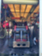 Professional tree trimming equipment organized inside service trailer