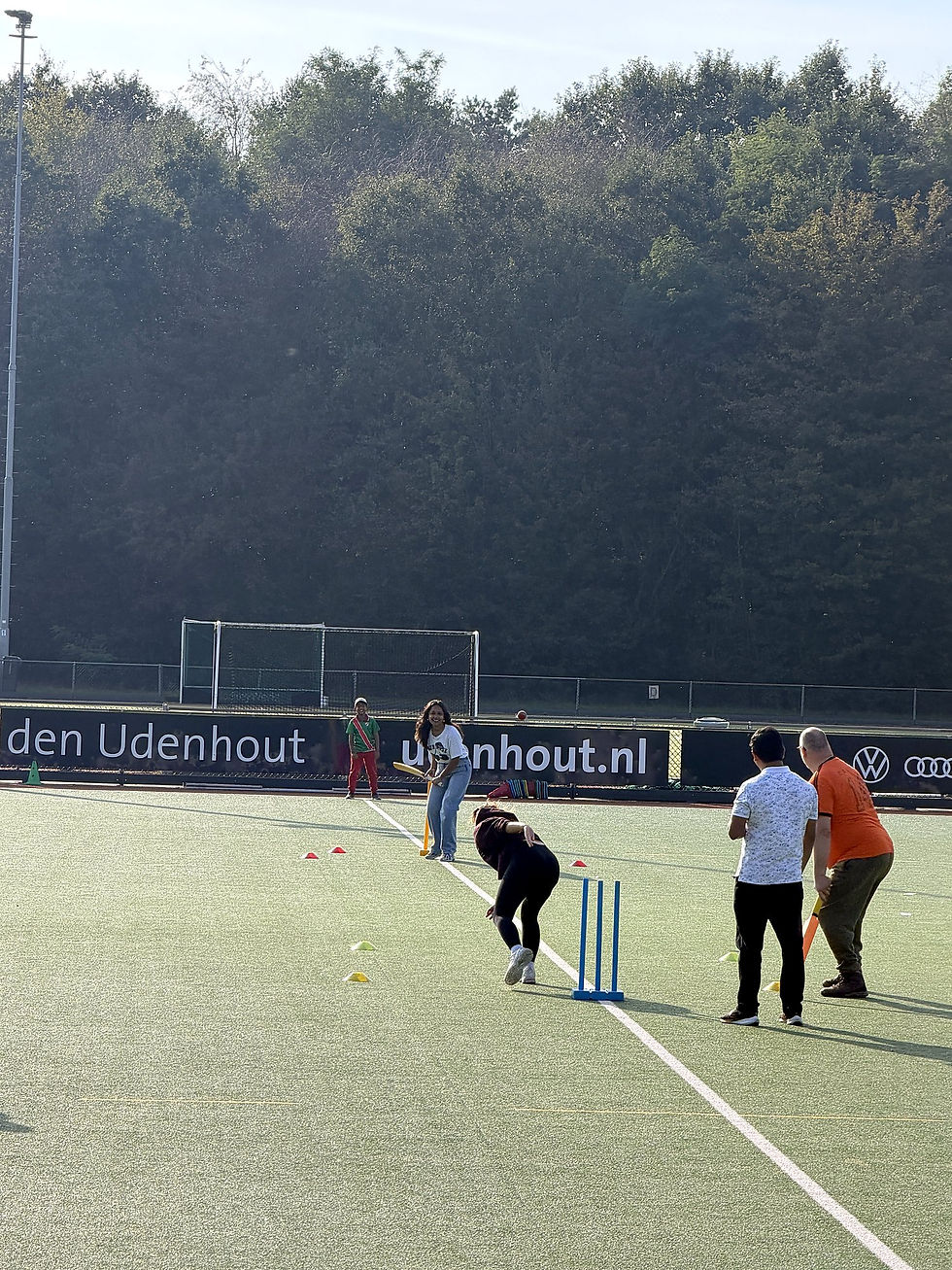 Parents and children playing a cricket match at MOP Cricket Club in Vught