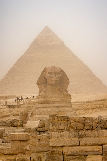 the sphinx in front of the giza pyramid on a hazy day