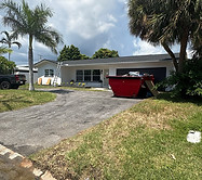 Residential home with a red dumpster on the driveway