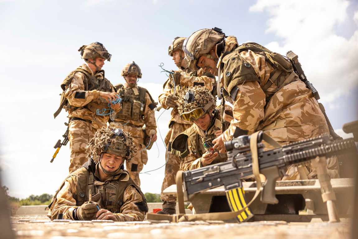 British soldiers in training, reviewing maps and planning strategies in the UK.