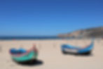 Traditional fishing boats on Nazaré beach in Silver Coast Portugal