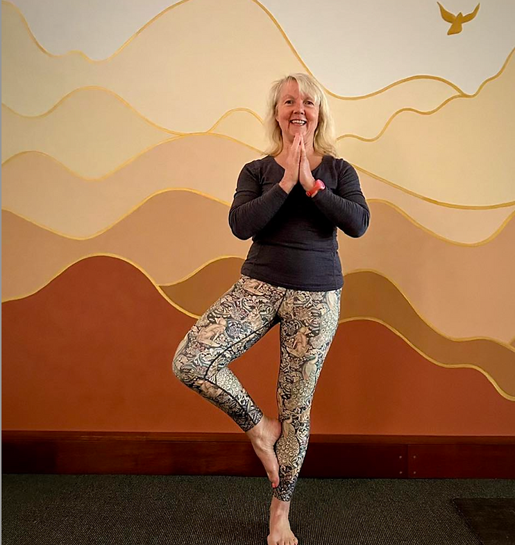 Francesca Davy doing yoga in front of the wall at Twine Yoga Studio.png