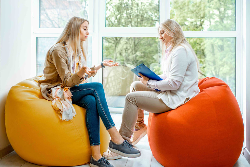 A childcare director having a difficult conversation with an educational leader sitting on bean bags