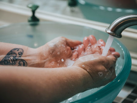 washing hands in a glass basin with low tox soap