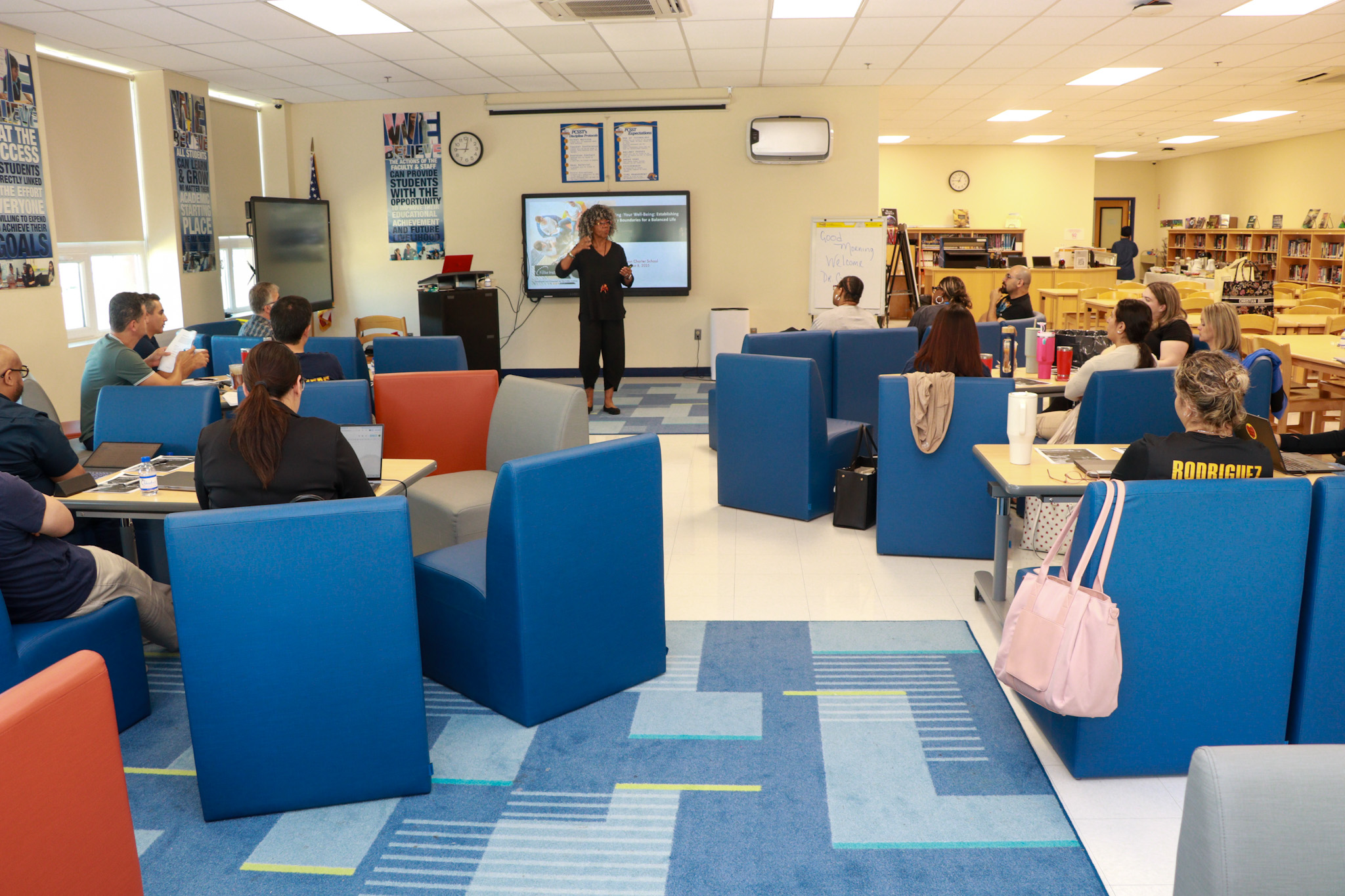 Facilitator leading a learning session with participants seated in small groups