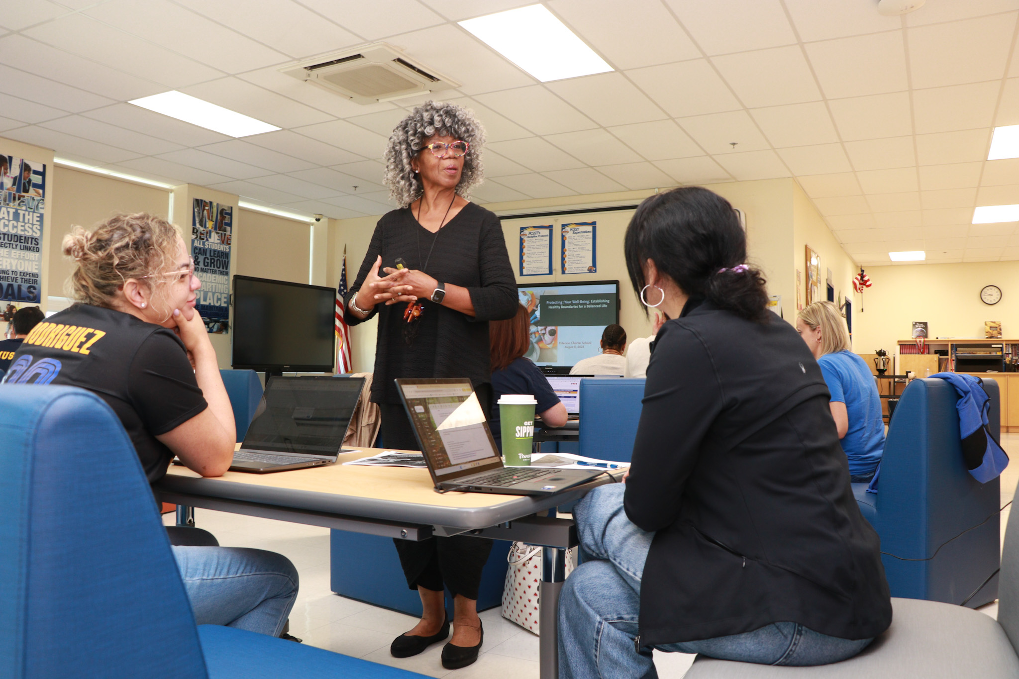 A facilitator and participants exchange ideas around a workshop table