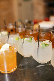Row of signature cocktails prepared for guests at a Texas wedding reception.