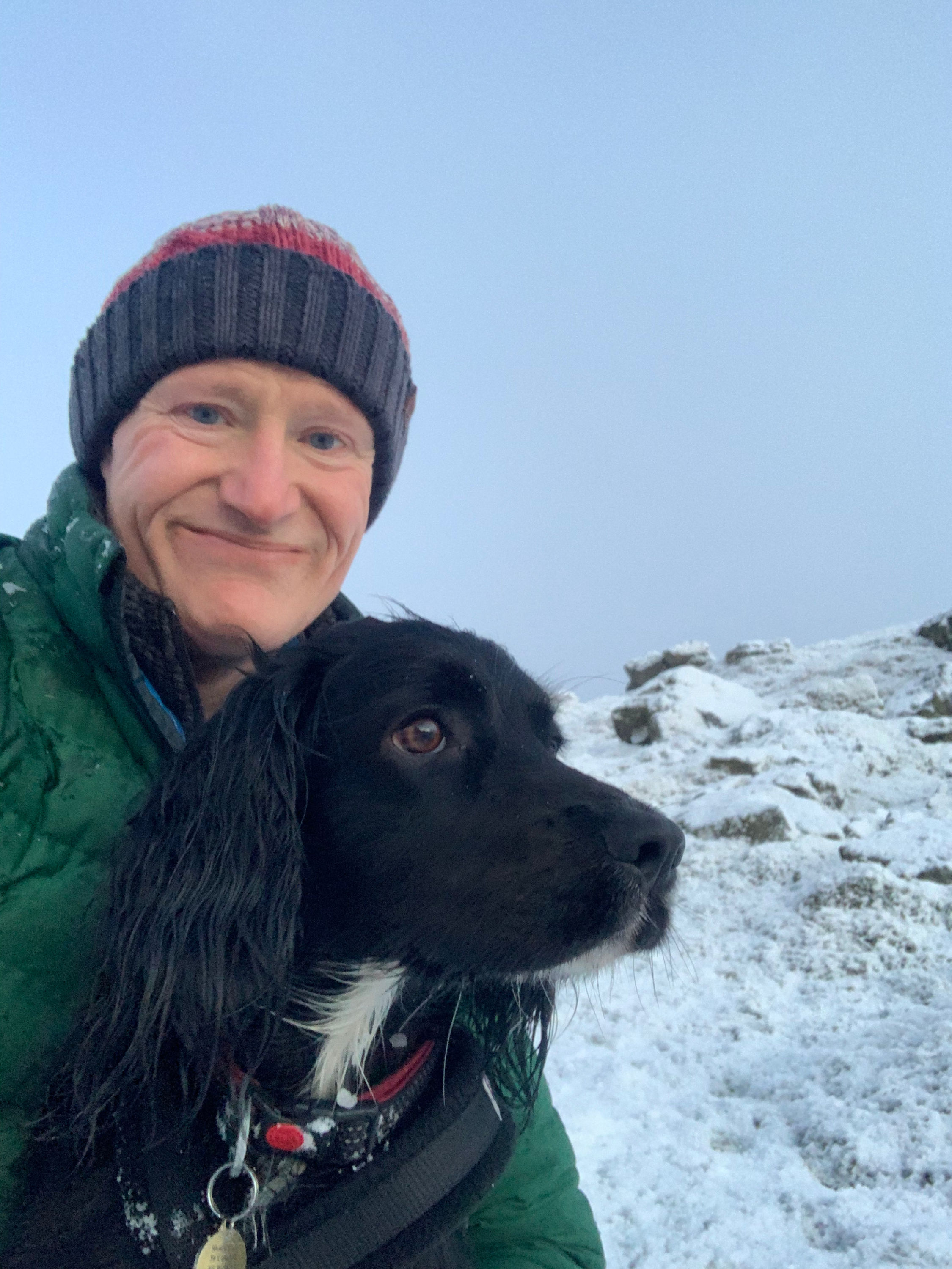Spaniel and owner in the snow