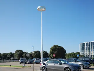 EV charging integrated into smart urban lighting infrastructure in a city parking area