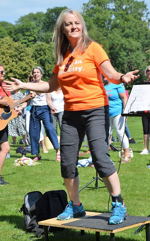 Woman on platform leading an outdoor activity