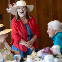 guests laughing together at the tea and symphony event