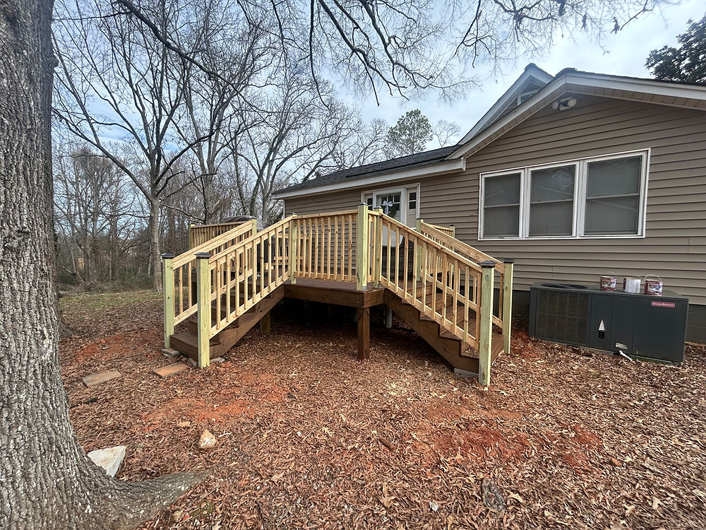 Custom construction of a new wooden deck and stairs for a home.