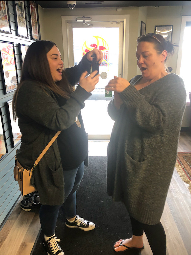 Daughter and mother see their tattoos for the first time.