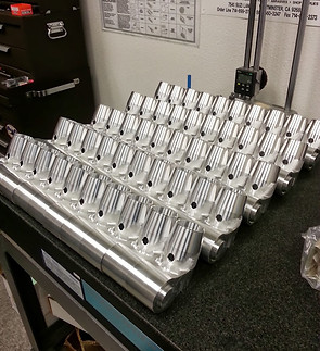 High-volume production run of precision turned aluminum components ready for final inspection