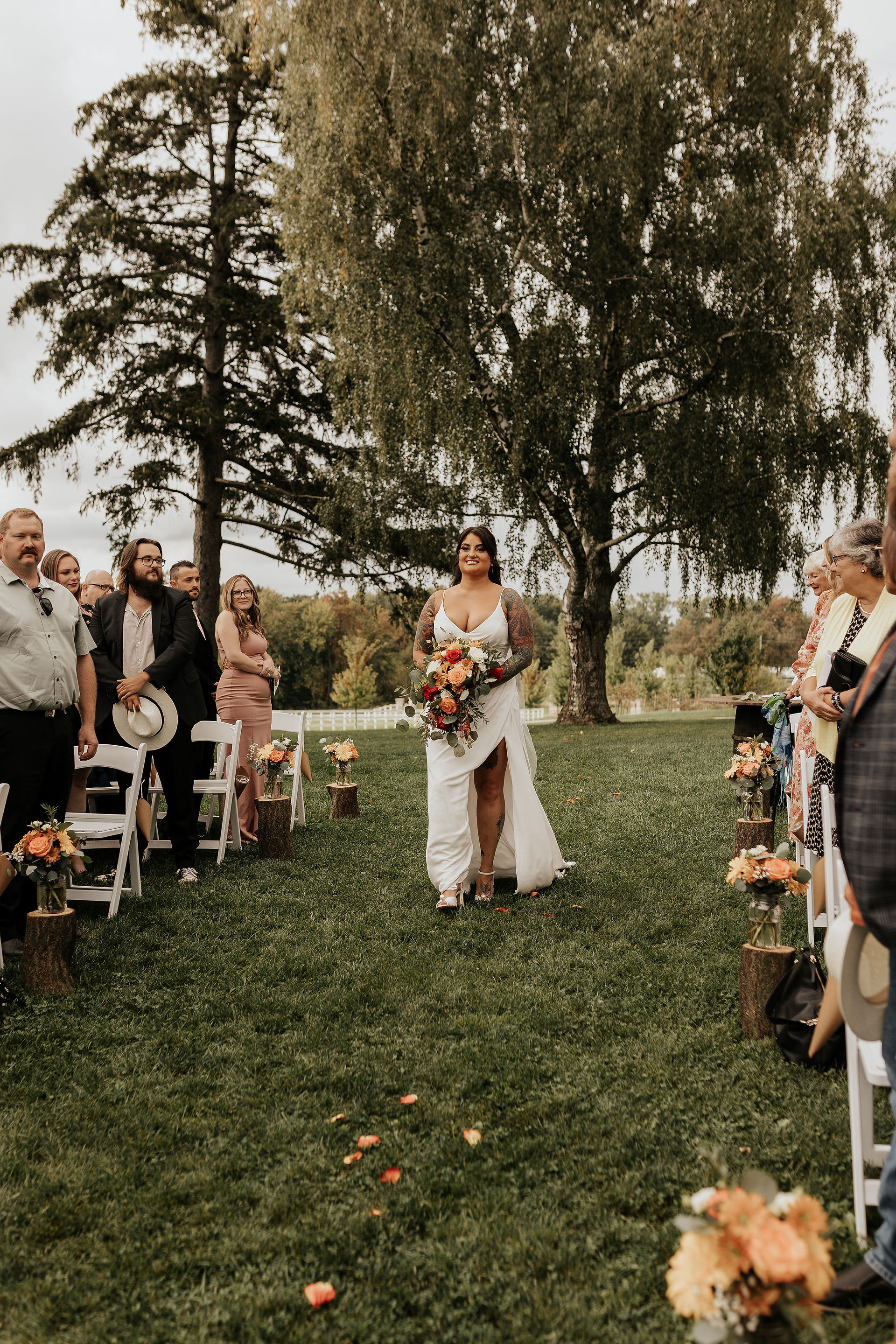 bride walking down the aisle at earth to table the farm