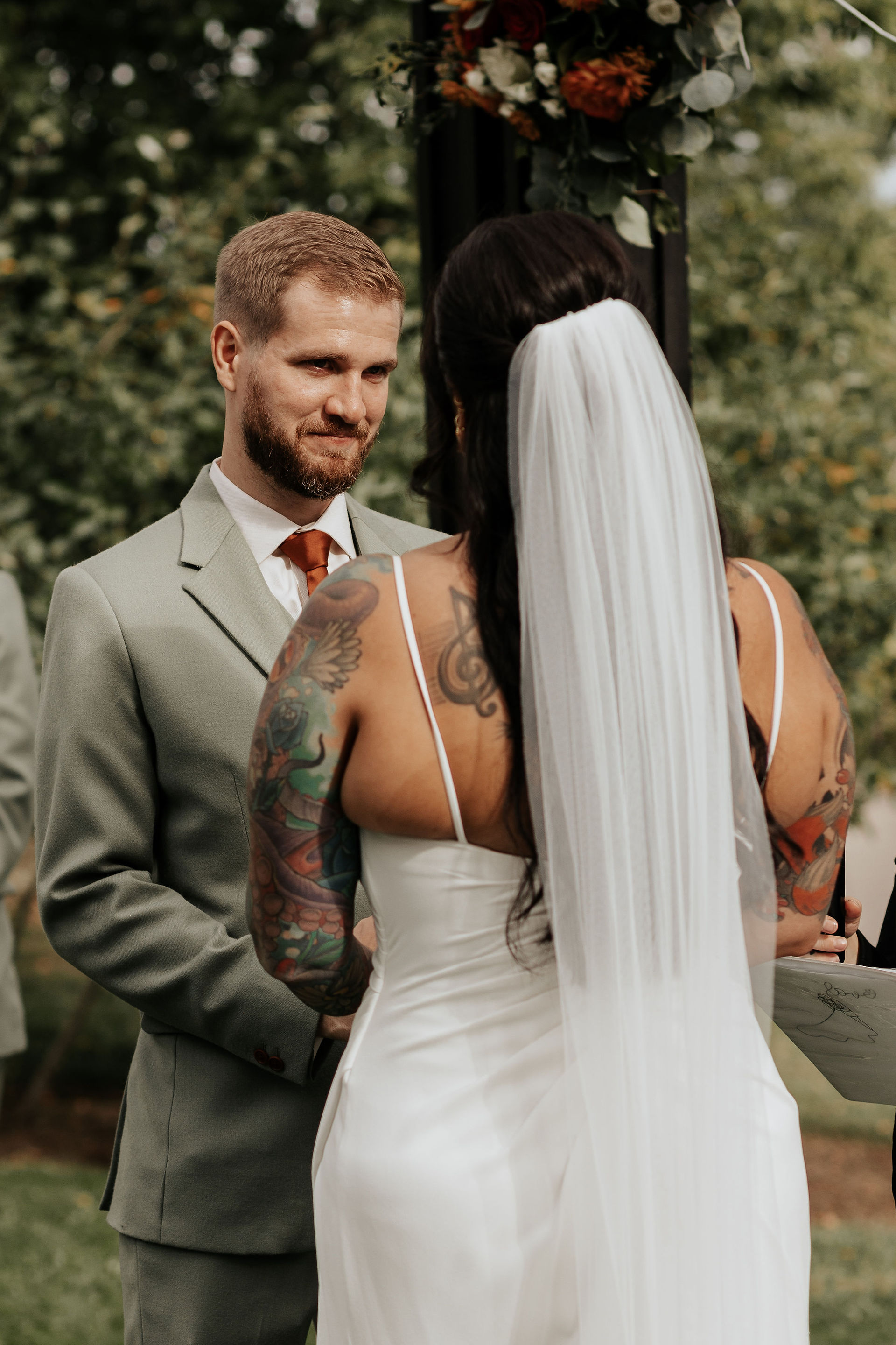 grooms reading vows during ceremony at earth to table the farm