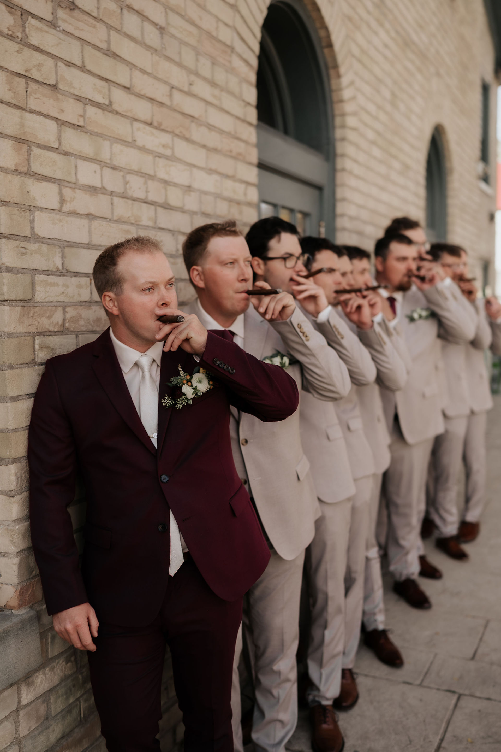 River’s Edge at The Arlington groom getting ready with groomsmen smoking cigars outside