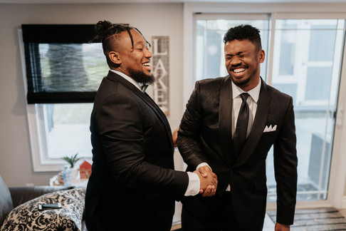 groom and best man shaking hands