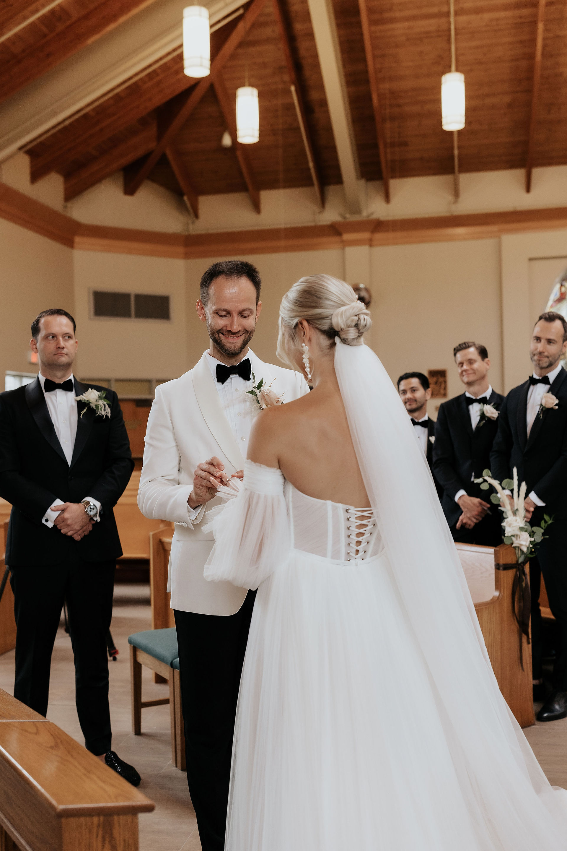 emotional groom during the ring exchange at their church ceremony