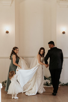 Flower girl helping bride during ceremony