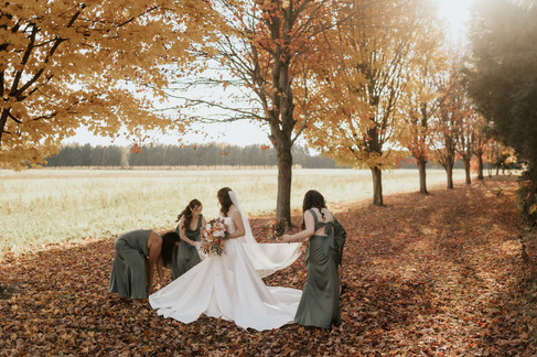 bridesmaids helping bride at cranberry creek gardens