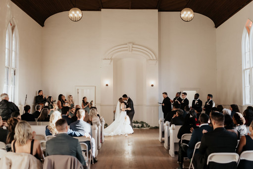Bride and groom share first kiss in cranberry Creek chapel
