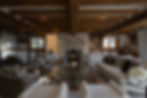 Property photography of large cosy living room with log burner and ceiling beams with afternoon autumn light