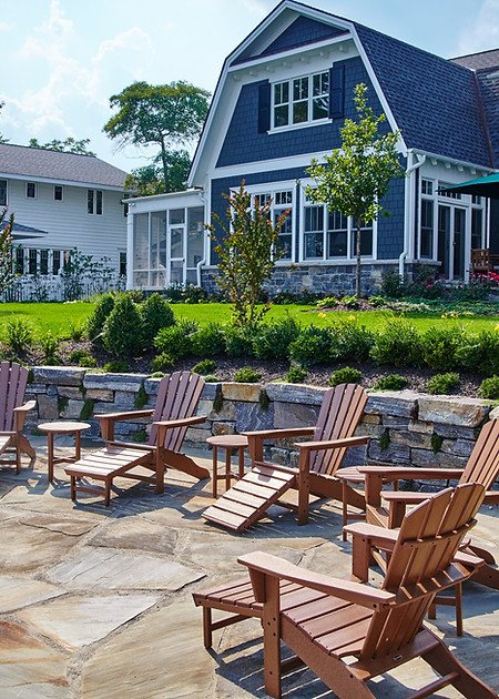 Suburban Backyard Patio with Adirondack Chairs and Lush Garden.jpg