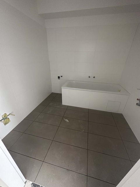 Badezimmer mit dunklen Fliesen von der All In Time Fliesen- & Plattenleger GmbH