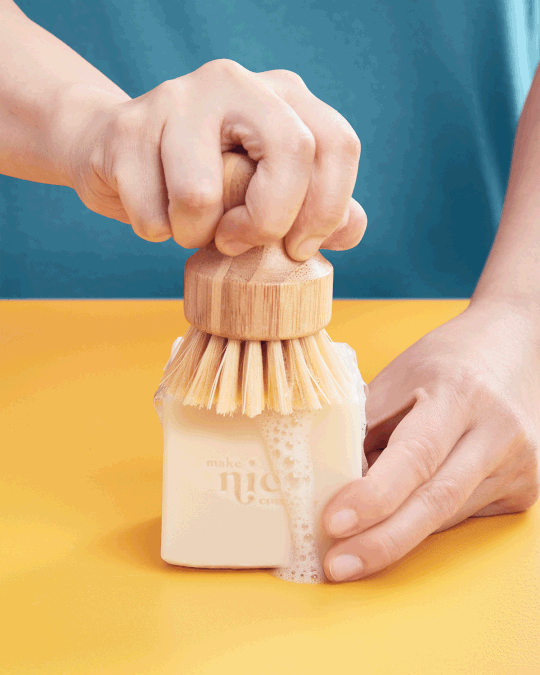 A moving gif image of a person demonstrating how to use a biodegradable sponge and solid dish soap made by The Make Nice Company in Vancouver, British Columbia. The biodegradable sponge and solid dish soap are waste-free alternatives to creating a sustainable home environment and kitchen.