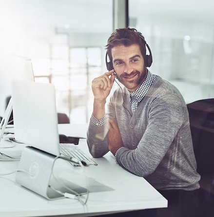 wow-image → service-with-smile-high-angle-shot-handsome-young-businessman-wearing-headset-while-sittin
